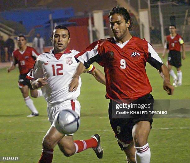 British Everton player, Egyptian selection captain, Ahmad Hossam "Mido" takes control over the ball from Gohar al-Menhari of the Tunisian national...