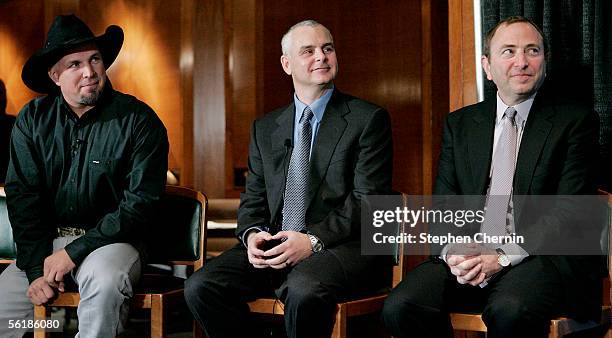Country singer Garth Brooks, NHL Players Association Executive Director Ted Saskin and NHL Commissioner Gary Bettman listen to a speaker during a...