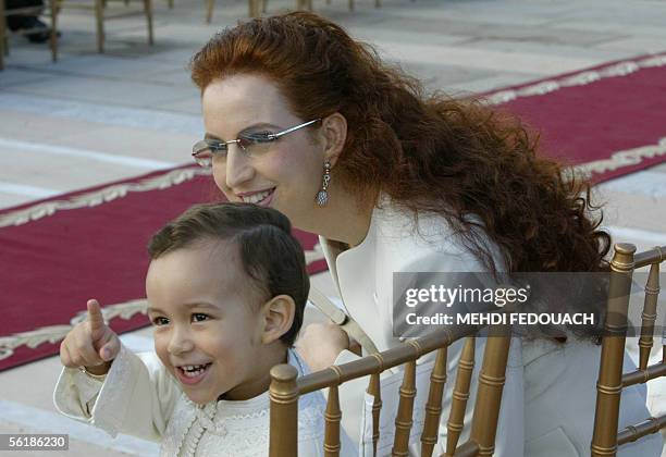 The son of Moroccan King, the Crown Prince Hassan points whilst his mother the Princess Lalla Salma looks towards his gesture 16 November 2005 as the...