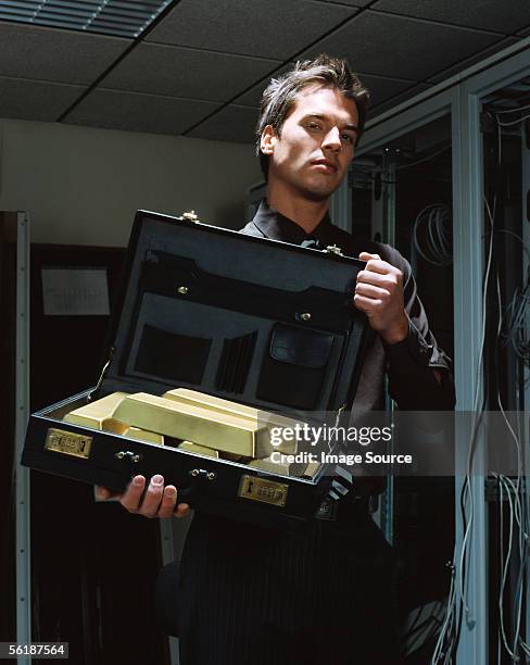 man with a briefcase of gold bars - gold bullion stockfoto's en -beelden