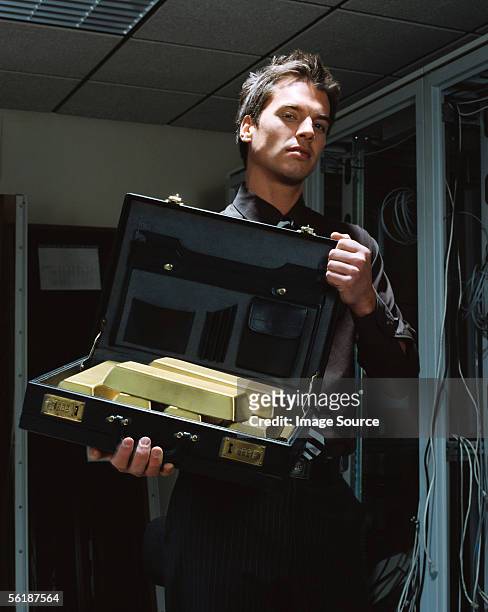 man with a briefcase of gold bars - stern gold stock pictures, royalty-free photos & images