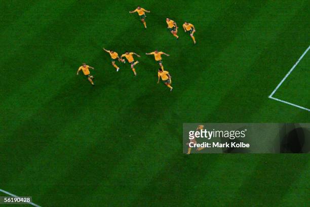 Australian players celebrate victory in the penalty shoot-out during the second leg of the 2006 FIFA World Cup qualifying match between Australia and...