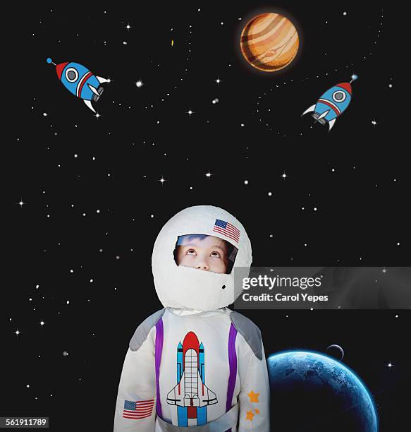 boy dressed as astronaut.cartoon in background - astronauta imagens e fotografias de stock