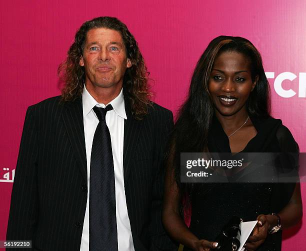 French coach Bruno Metsu of Qatar's Al-Gharrafa club arrives with his wife at a reception for the official launch of a charity program to raise money...