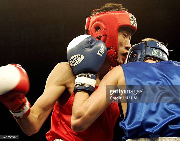 Kim Song Guk of North Korea fights against Sergey Kunitsyn of Belarus during their 57kg category preliminary match of 13th World Senior Boxing...