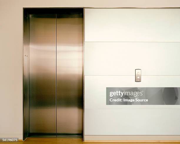 closed elevator doors - elevator doors stock-fotos und bilder