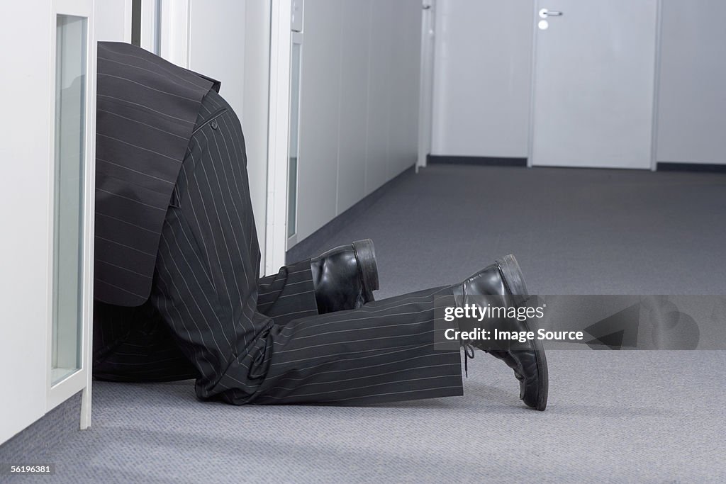 Businessman crawling on floor