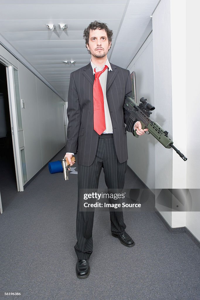 Businessman with a rifle and handgun