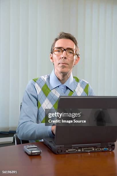 office worker using laptop computer - nerd sweater stock pictures, royalty-free photos & images