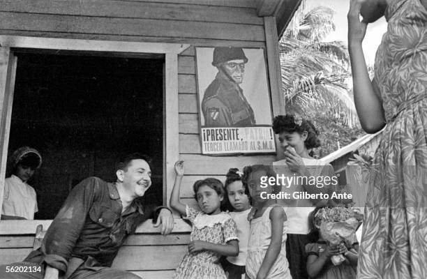 Rauel Castro talking with a family of countrymen. Cuba, 1964.