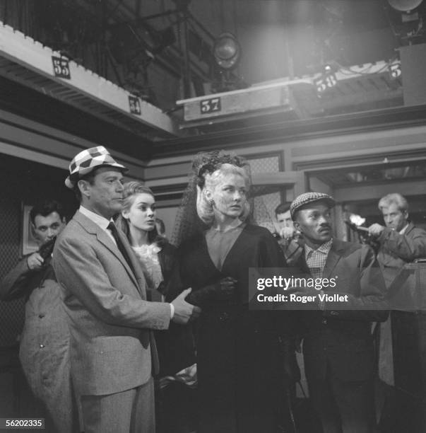 Eddie Constantine, Elga Andersen, Harold Nicholas and Genevieve Grad in the film of Pierre Grimblat "L'Empire de la nuit". France, 1962.