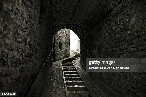 winding stone staircase in tunnel - eric van den brulle stock pictures, royalty-free photos & images