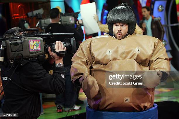 Actor Ryan Reynolds appears in a sumo wrestling suit onstage during MTV's Total Request Live at the MTV Times Square Studios on November 17, 2005 in...