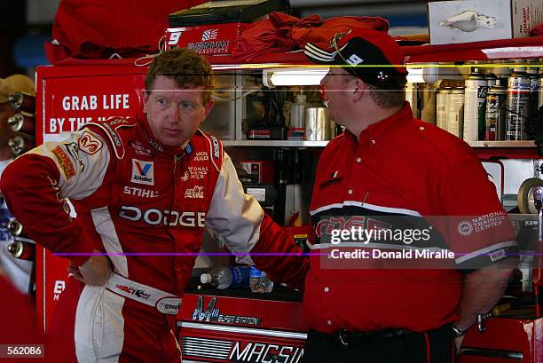 Bill Elliott, driver of the Evernham Motorsports Dodge Intrepid R/T, stands in the garages during the practice for the Aaron's 499 at Talledega...