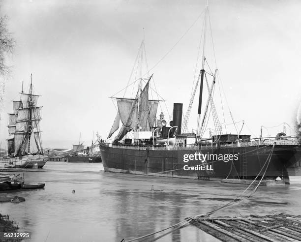 Ships in a harbour . Seville , about 1900.