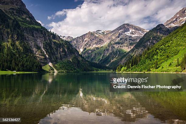 rowing boat on mountain lake - austria stock-fotos und bilder