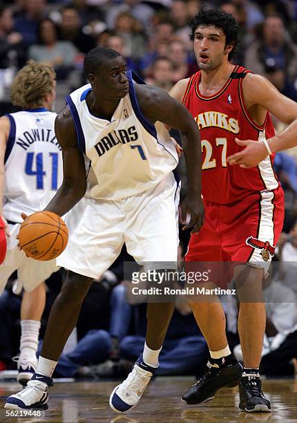 Center DeSagana Diop of the Dallas Mavericks moves the ball against Zaza Pachulia of the Atlanta Hawks at the American Airlines Center on November...