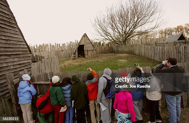 Visitors take in the sites at the 1627 Pilgrim Village at "Plimoth Plantation" where role-players portray Pilgrims seven years after the arrival of...