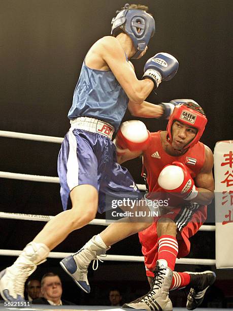 Yuriolkis Gamboa Toledano of Cuba fights with Kim Song Guk of North Korea during their 57kg category quarterfinal of 13th World Senior Boxing...