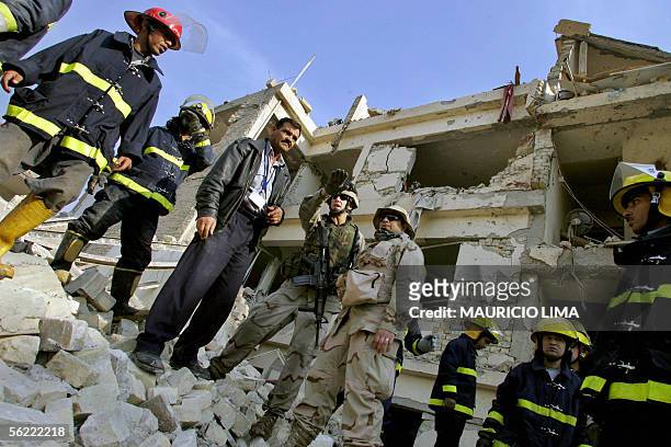 Members of Iraqi civil defense listens the safety procedures to clean the area from a US soldier from 4-64 Battalion, 3rd Infantry Division as they...