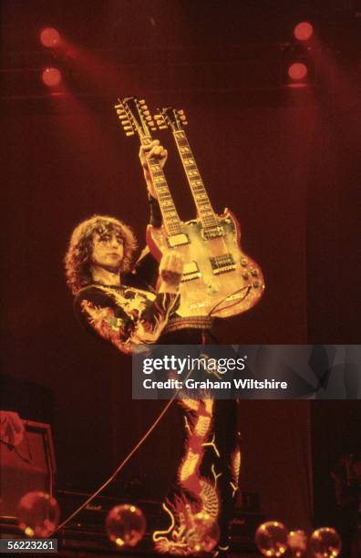 English guitarist Jimmy Page playing a double-necked six and twelve stringed guitar during a Led Zeppelin concert at Earl's Court, London, 18th May...