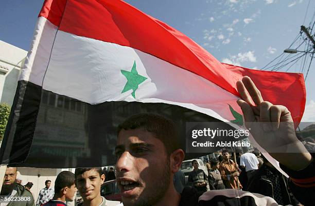 Palestinian youth holds a Syrian flag during a pro-Syrian demonstration on November 18, 2005 in Gaza City, Gaza Strip. Hundreds of Palestinians...