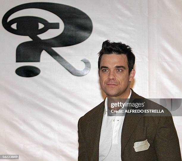 British pop singer Robbie Williams poses for photographers before a press conference in Mexico City, 18 November 2005. Robbie Williams arrived in...