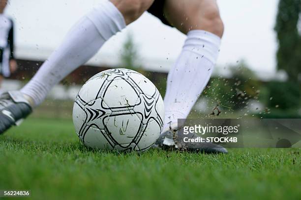 soccer player kicking a football - boot kicking stock pictures, royalty-free photos & images