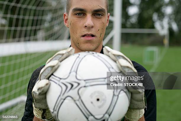 goalkeeper holding football in his hands - football player face stock pictures, royalty-free photos & images