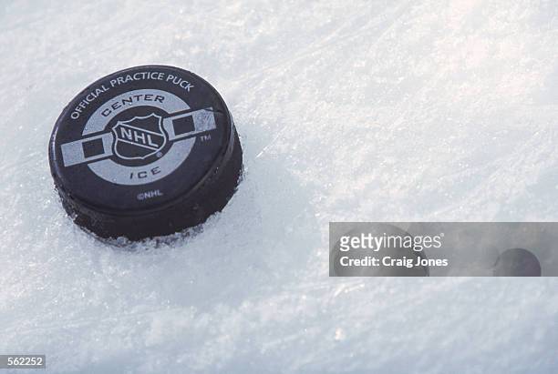 This is a close up of a hockey puck. The picture was taken during the NHL game between the Carolina Hurricanes and the Minnesota Wild at the...