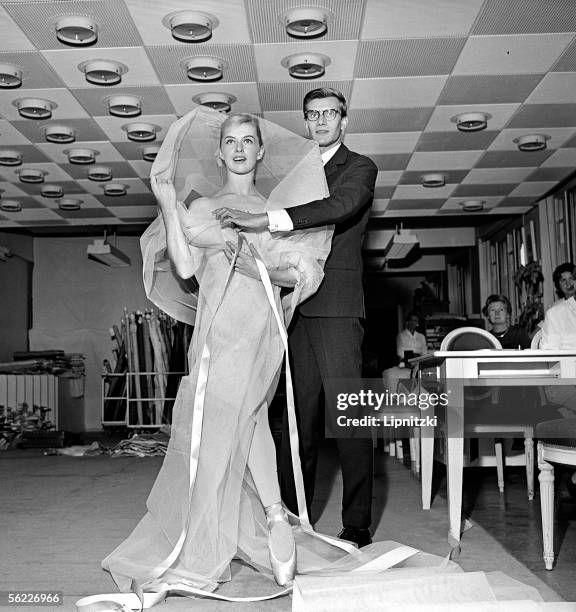 Yves Saint Laurent, French couturier and Tessa Beaumont, dancer, at Dior's. September, 1959. LIP-10462-005.