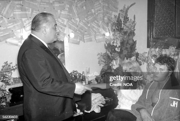 Bruno Coquatrix, Sylvie Vartan and Johnny Hallyday in the dressing room of Johnny Hallyday. Paris, Olympia. HA-1022-3.