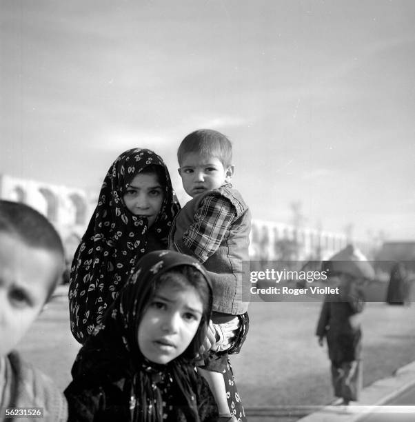 Iranian woman and her children. Isfahan , Royal square. 1958.