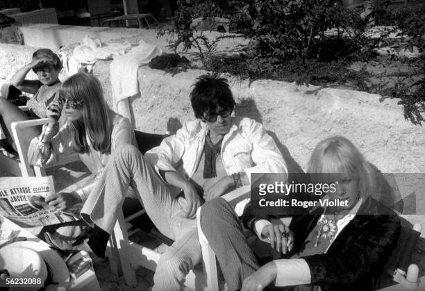 Keith Richards, Rolling Stones' guitarist, and Anita Pallenberg at his left. Festival of Cannes, 1967. HA-1474-1.