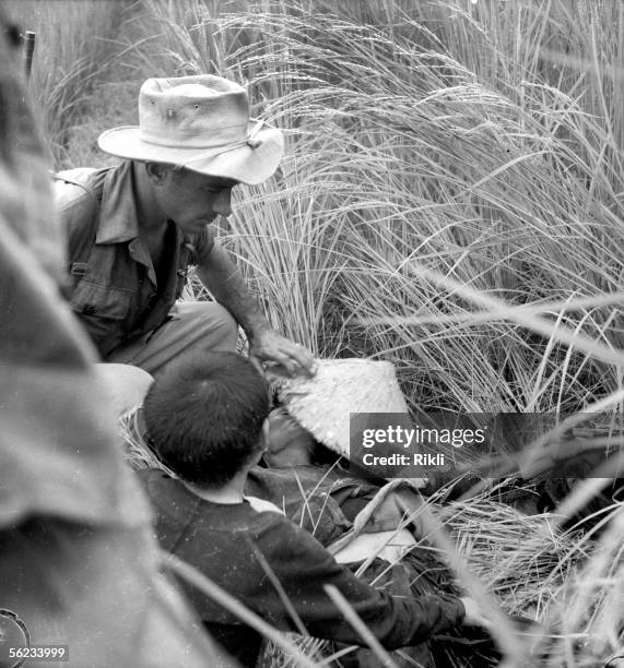 Indo-China war. French legionary discovering the corpse of Vietnamese corpse.