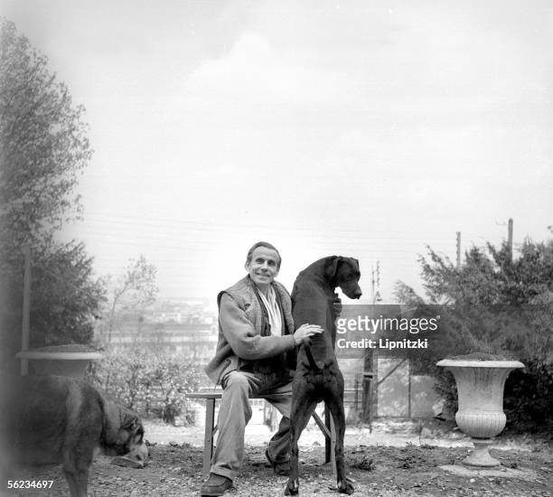 Louis-Ferdinand Celine , French writer, with his dogs. Meudon, about 1955.