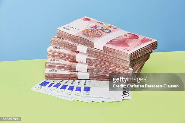 chinese rmb currency stacked on euros - yuan symbol stock-fotos und bilder