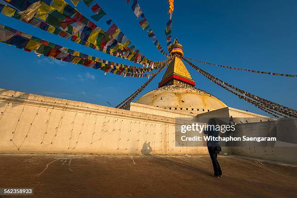 a photographer taking photo of boudhanath stupa - bodnath stock-fotos und bilder