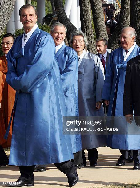 Asia-Pacific Economic Cooperation leaders clad in traditional Korean long coats called "durumagi", Mexican President Vincente Fox, United States...