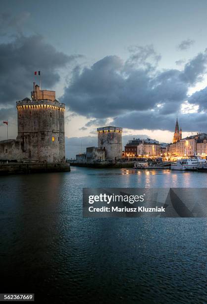 la rochelle harbour towers at dusk - la rochelle stock pictures, royalty-free photos & images