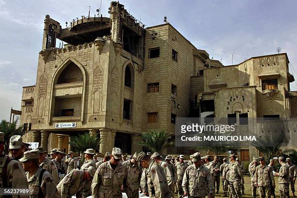 Troops from 4-64 Armor Regiment, 3rd Infantry Division gather in a field area in front of what was one of the Saddam Hussein's presidential palaces,...