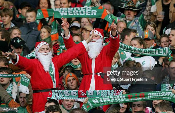 Fans in Father Christmas costumes cheer during the Bundesliga match between Werder Bremen and VFL Wolfsburg at the Weser Stadium on November 19, 2005...