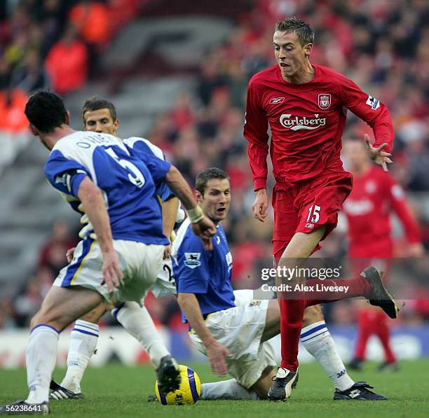 Peter Crouch of Liverpool battles for the ball with Andrew O'Brien of Portsmouth during the Barclays Premiership match between Liverpool and...