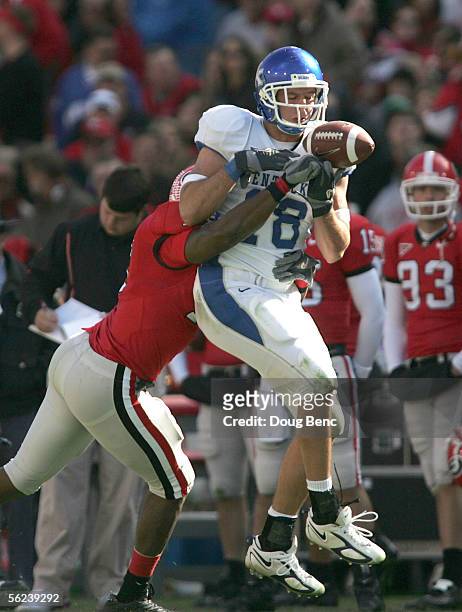 Tight end Jacob Tamme of the Kentucky Wildcats can't make the catch under the pressure from safety Greg Blue of the Georgia Bulldogs on November 19,...