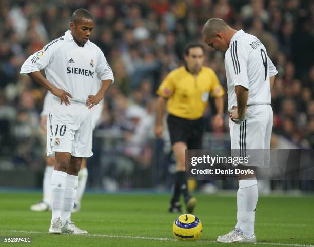 Robinho and Ronaldo of Real Madrid wait to take the kick off after Barcelona scored a goal during a Primera Liga match between Real Madrid and F.C....
