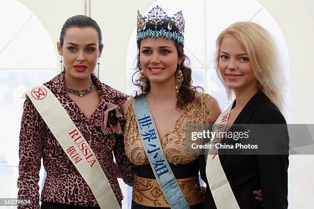 Miss World 2004, Maria Julia Garcia Mantilla of Peru poses for photographers with Miss World 2005 contestants Yulia Ivanova of Russia and Irina...