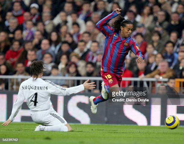 Ronaldinho of Barcelona gets past Sergio Ramos of Real Madrid during a Primera Liga match between Real Madrid and F.C. Barcelona at the Bernabeu on...
