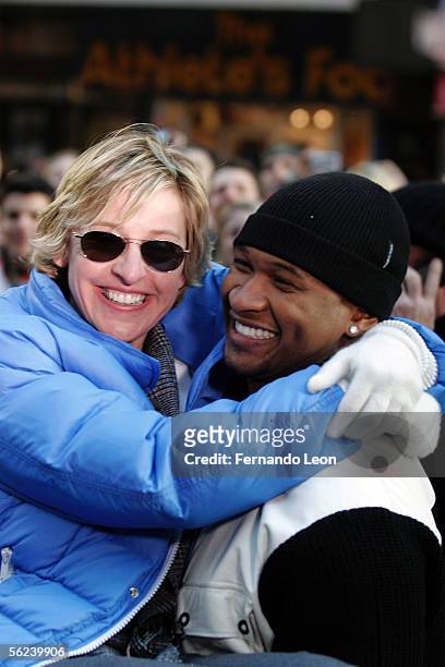 Singer Usher picks up host Ellen DeGeneres during a taping of "The Ellen DeGeneres Show" in Times Square November 19, 2005 in New York City.