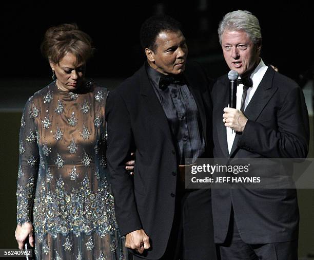 Boxing legend Muhammad Ali and wife Lonnie listen to former US President Bill Clinton on stage, 19 November 2005, during the Grand Opening Gala for...