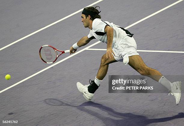 Swiss world number one Roger Federer stretches for a shot from David Nalbandian of Argentina in the final of the Tennis Masters Cup in Shanghai 20...